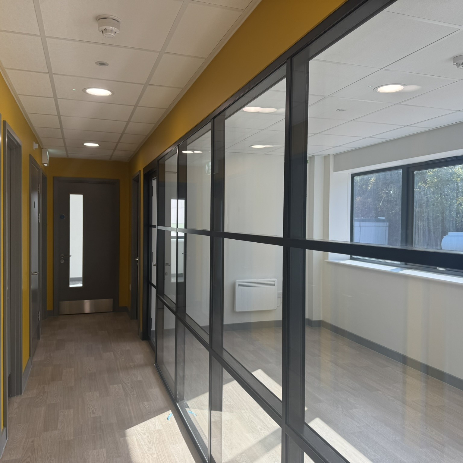 hospital corridor with mural on the wall