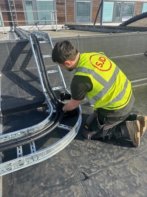 Roof work at the lister 2 Apprentice electrician at work connecting wires
